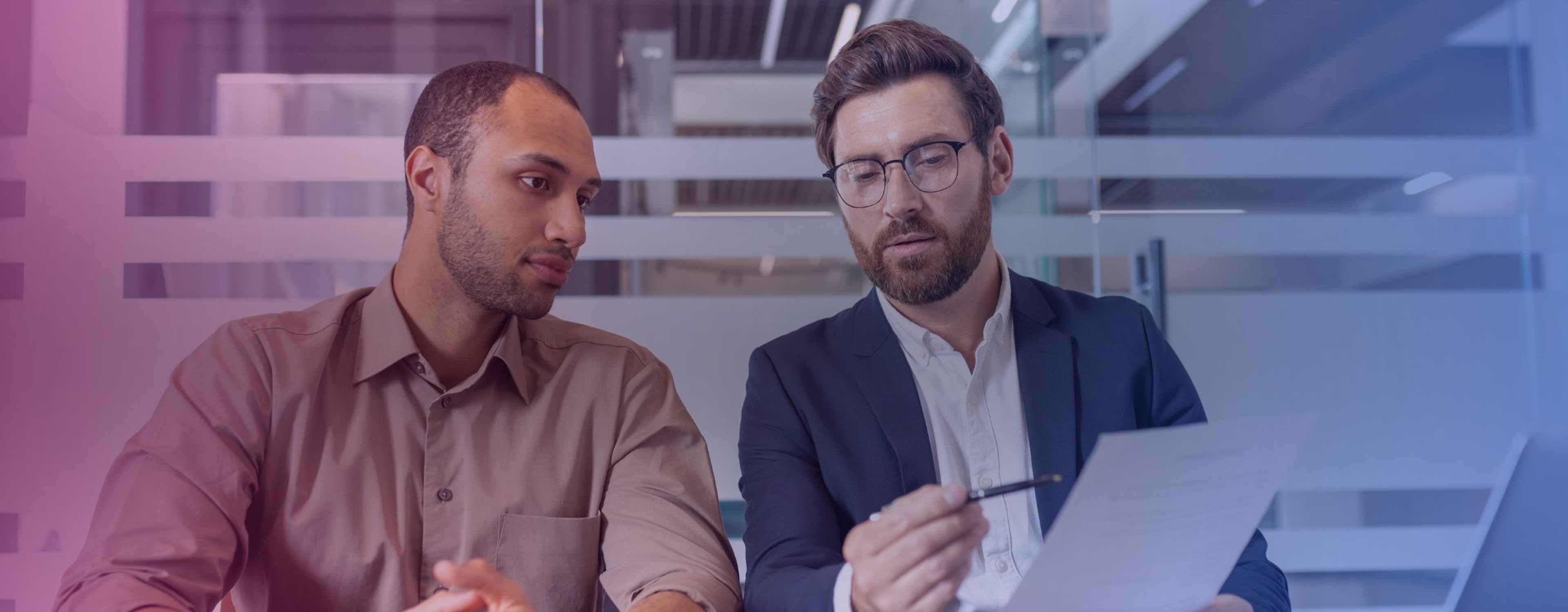 Businessmen looking over a work document together