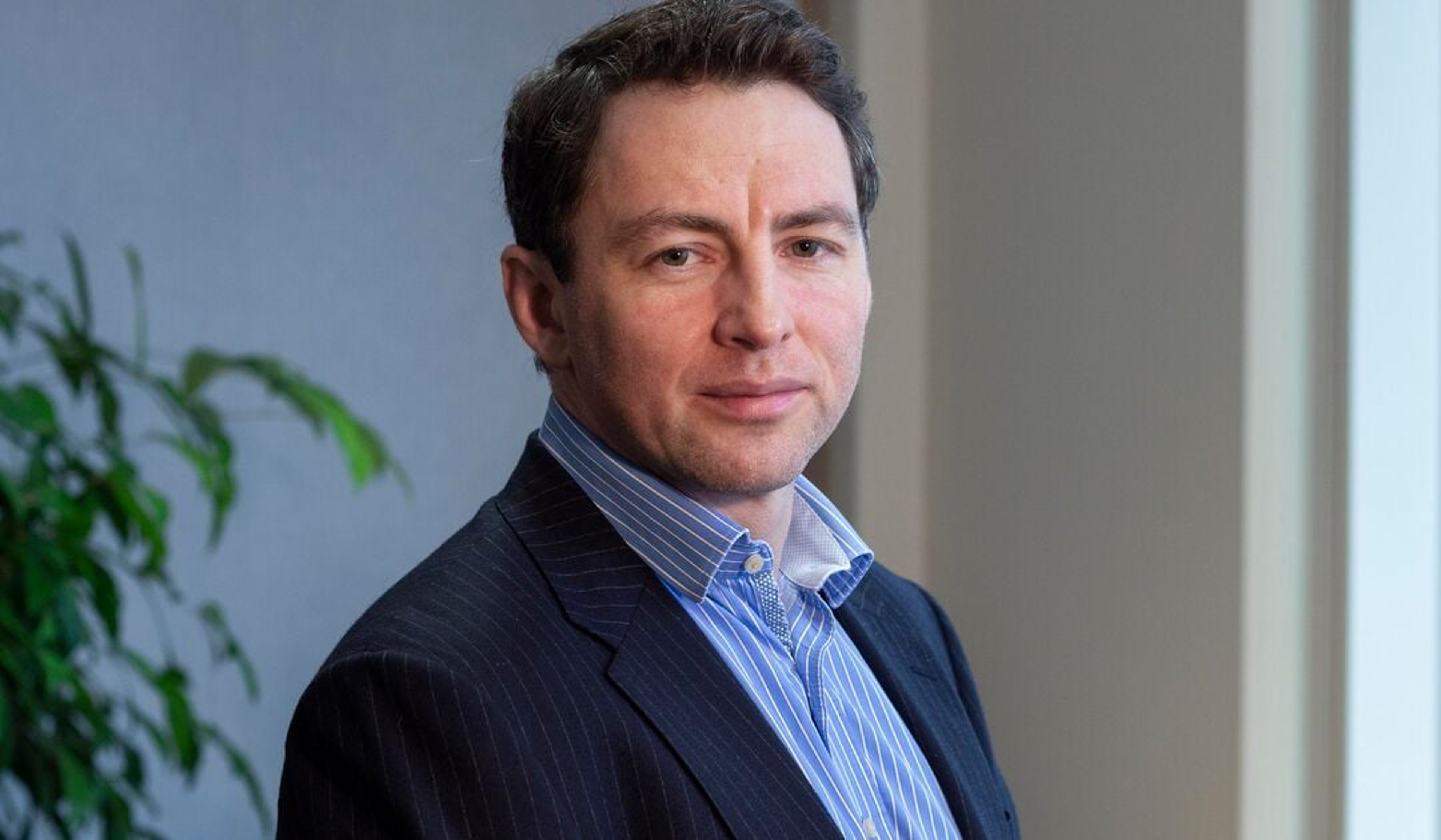 A headshot of Oliver John