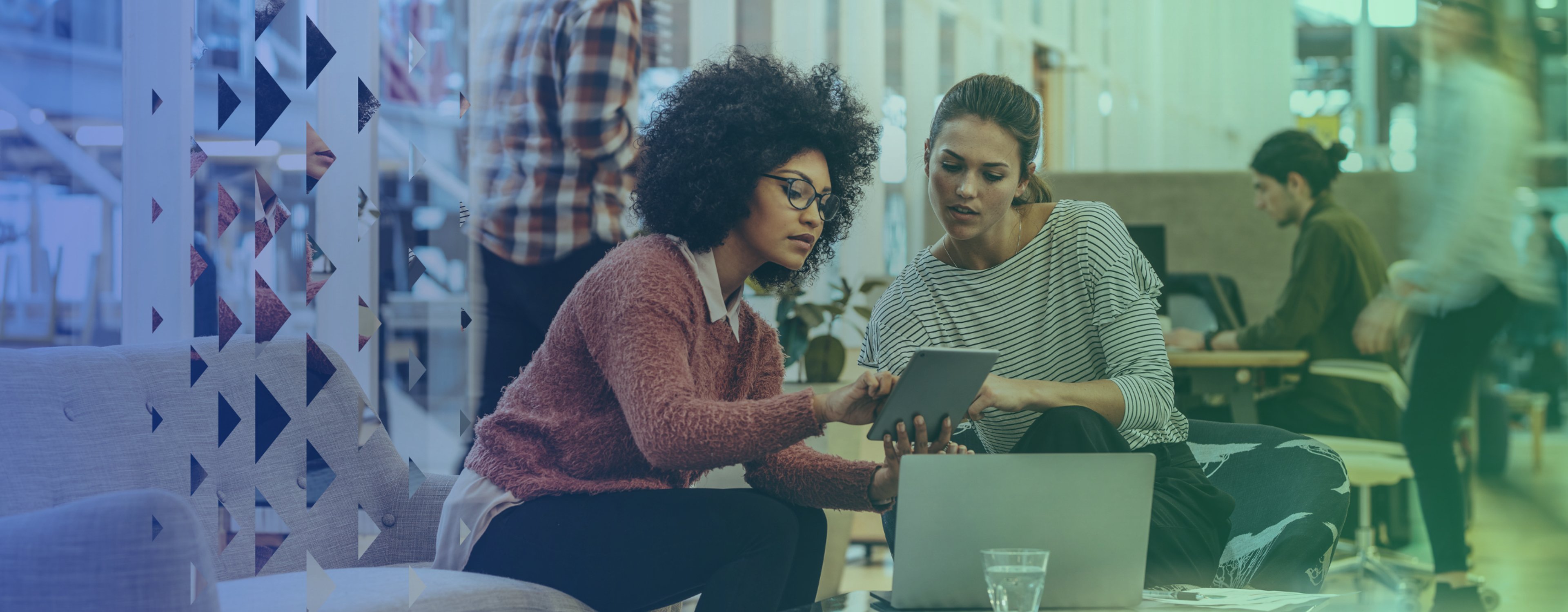 Two employees looking at a screen together