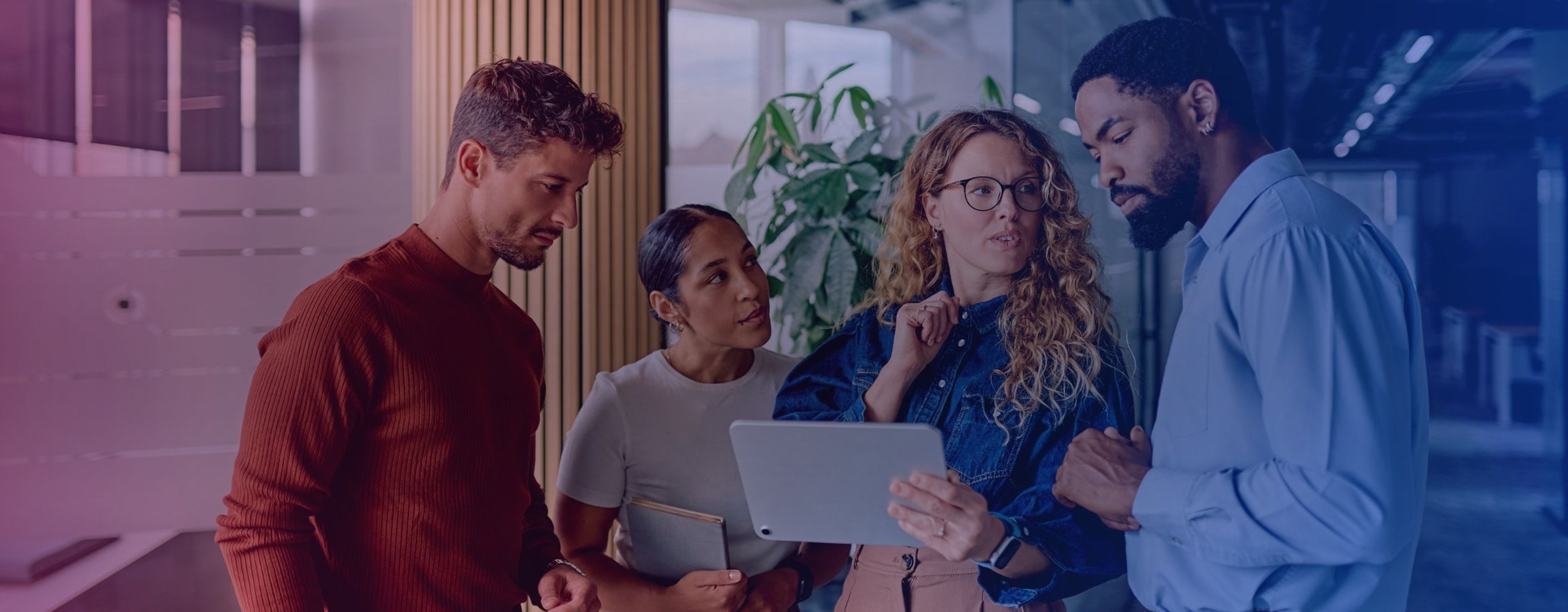 Business team collaborating, discussing project on a tablet