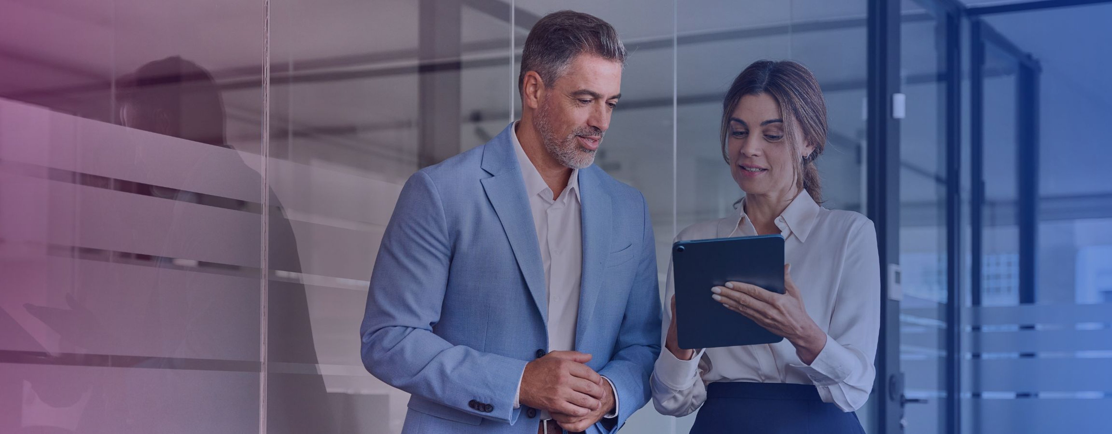Corporate employees looking at an electronic tablet