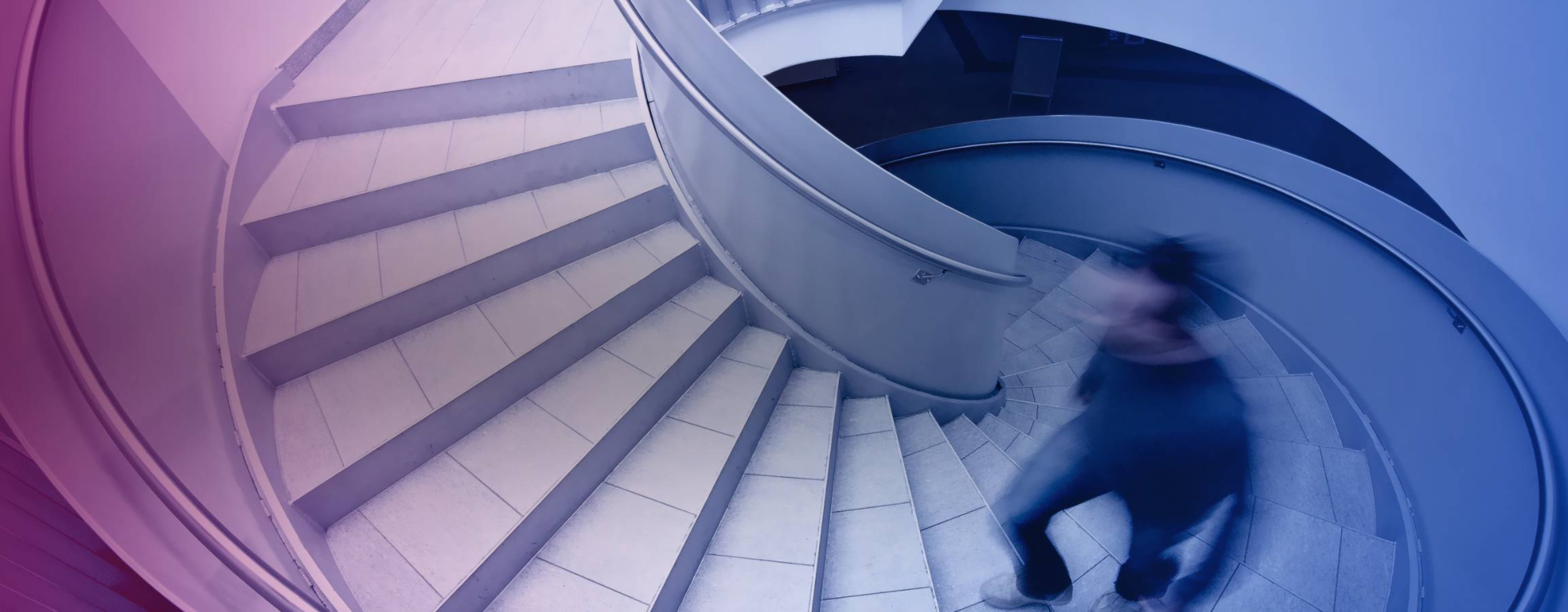 Man walking up a spiral staircase